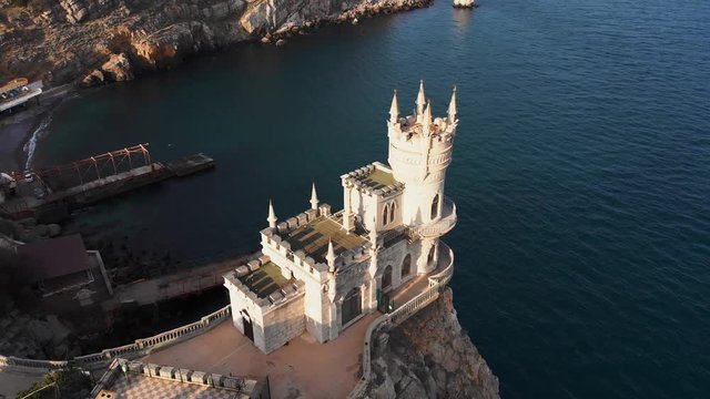 Swallow Nest aerial drone shot, ancient castle on top of mountain cliff near sea Yalta region, Crimea. Beautiful famous palace architecture and amazing nature landscape