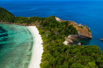 Aerial drone view of a deserted tropical island with beach and shallow coral reef (Stewart Island, Mergui Archipelago, Myanmar)