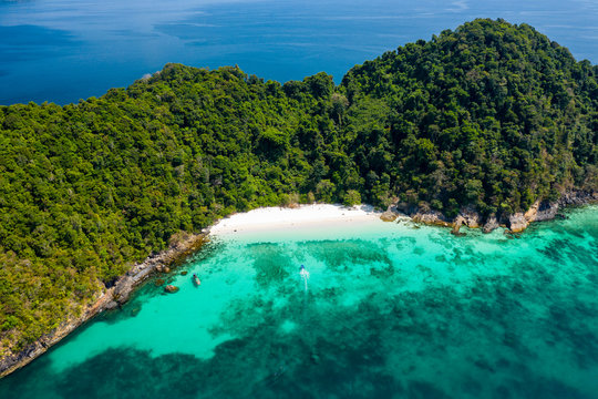 Aerial drone view of a beautiful deserted tropical island with lush foliage and a sandy beach (Ahtet Le Ywe Island, Mergui Archipelago, Myanmar)