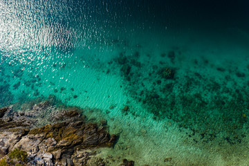 Aerial drone view of a shallow coral reef off a tropical island