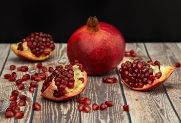 Ripe pomegranate fruit on old brown wooden vintage background.