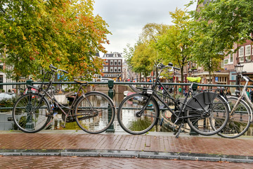 Bikes on bridge over Amsterdam canal, Amsterdam, Netherlands