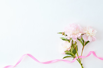 Fototapeta na wymiar Flat lay composition with light pink peonies on a white background