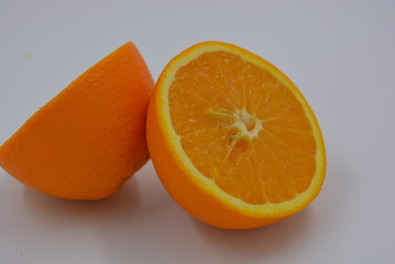 Bright orange halves of sliced ripe orange, two halves of whole orange, wholesome food and fruit,...