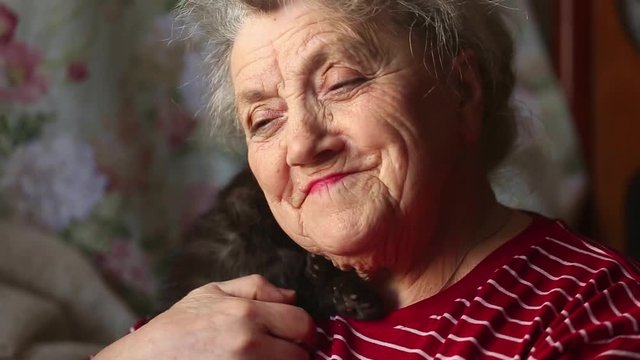 Smile And Happy Elderly Woman With Cat