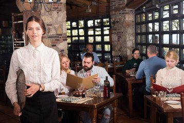 Waitress welcoming in rustic restaurant