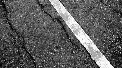 Fototapeta premium crack and texture of asphalt road with white dashed line top view background.
