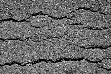 crack and texture of asphalt road - top view background.