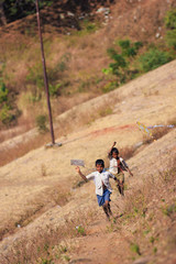 Naklejka premium indian child playing with kite