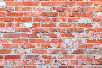 wall of bright old red brick as beautiful loft-style background for modern interior design and exterior of industrial premises, apartments and houses