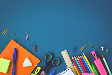 School supplies on blue background. Top view. Copy space.