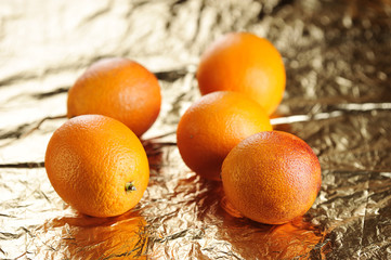 red oranges on gold foil