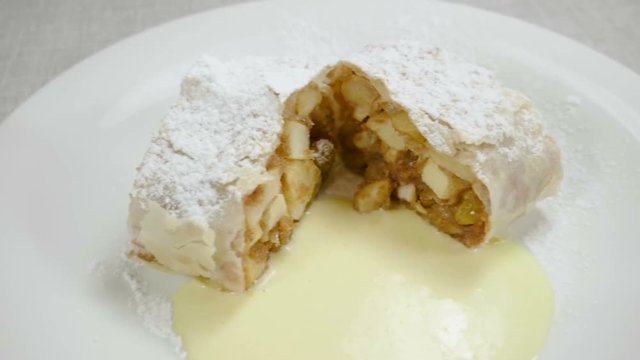 Close-up shot of strudel with apples, ice cream and mint. Slow motion. HD