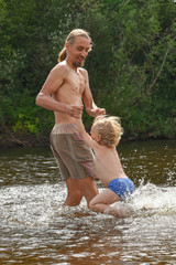 father teaching his little son to swim, they are happy.vacation. family, summer time, beach.