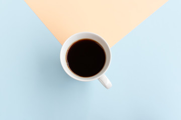Directly above view of cup of coffee on dual tones background