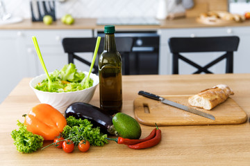Fresh and juicy vegetables are on the table in the kitchen. Preparation of healthy food