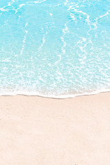 Fototapeta na wymiar Soft wave of blue sea on sandy beach. Summer Background. Copyspace
