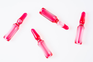 Pharmaceutical medicine ampoules with vitamins, antibiotics or dietary supplement on white background top view. Medical pharmacy, injections, therapy concept