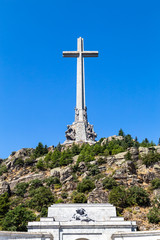 The gigantic cross on the top of the Valley of the Fallen (Valle de Los Caidos), the burying place of the Dictator Franco on the Sierra the Guadarrama, Madrid, Spain