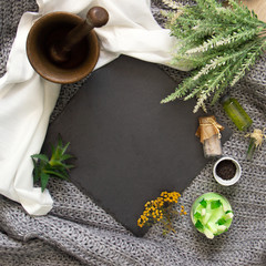 natural slate slab surrounded by herbs, alchemy appliances, potions and ingredients lies on a...