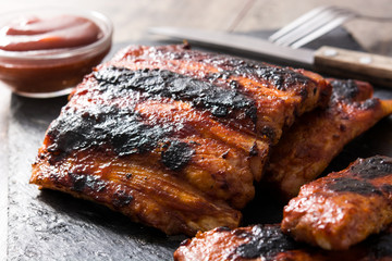 Grilled barbecue ribs on wooden table