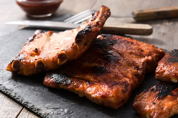 Grilled barbecue ribs on wooden table