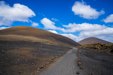 Spain, Lanzarote, Volcanic trail through colorful volcanic mountains and lava landscape