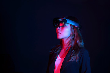 Business woman try vr glasses hololens in the dark room | Portrait of young asian girl experience...