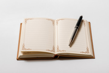 open vintage notebook and pen on white background