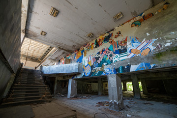 Fototapeta na wymiar PRIPYAT, UKRAINE - June, 2016: Ruin in foyer of Energetik Palace of Culture, dead abandoned ghost town of Pripyat in Chernobyl nuclear power plant alienation zone, Ukraine