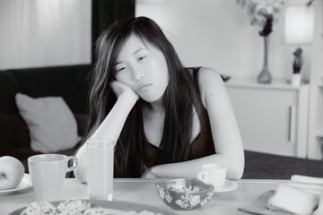 Unhappy sad Chinese woman tired at home
