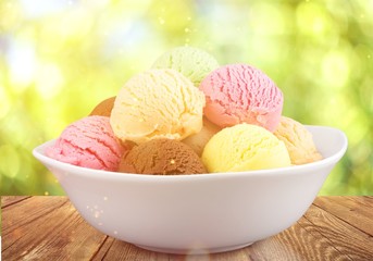 Ice cream scoops in bowl on white background
