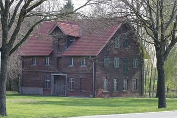 old red brick house between trees