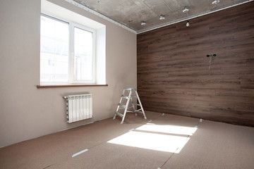 Empty room. Floor repair in private apartment. Moving to a new home. Interior renovation. Tile laying.