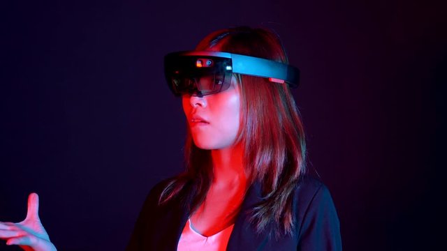 Business woman try vr glasses hololens in the dark room | Portrait of young asian girl experience ar communication | Future technology concept
