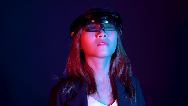 Business woman try vr glasses hololens in the dark room | Portrait of young asian girl experience ar communication | Future technology concept