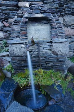 A tap with flowing water in a village in Georgia,