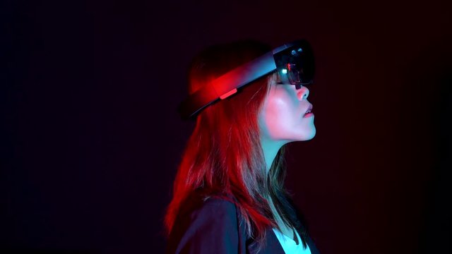 Business woman try vr glasses hololens in the dark room | Portrait of young asian girl experience ar communication | Future technology concept