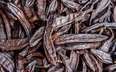Close up picture of dried organic carobs.