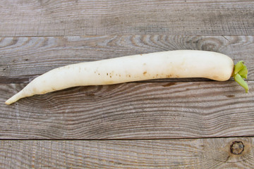 Long white daikon radish on rustic wooden table