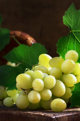 Green grapes on old wooden table, summer still life, selective focus