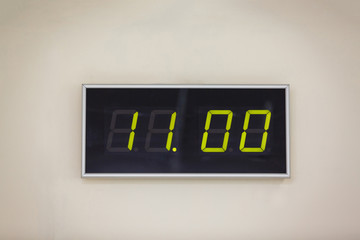 Black digital clock on a white background showing time 11.00