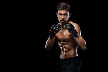 Fototapeta na wymiar Sportsman man boxer fighting on black background with shadow. Copy Space. Boxing sport concept.