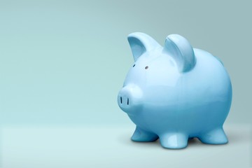 Hand putting coin to piggy bank