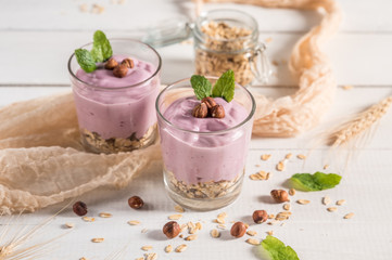 Healthy breakfast parfait with yogurt, granola and nuts in glass