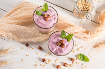 Healthy breakfast parfait with yogurt, granola and nuts in glass