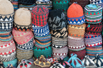 Various stacked knitted caps / Background from different stacked knitted hats.