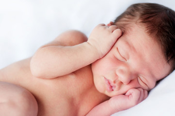 Fototapeta na wymiar Newborn Baby Sleeping Peacefully on Soft Blanket