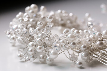 Close up of pearl beads isolated on white background. Hair accessory.