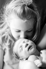 Big Sister Kissing Newborn Baby Brother